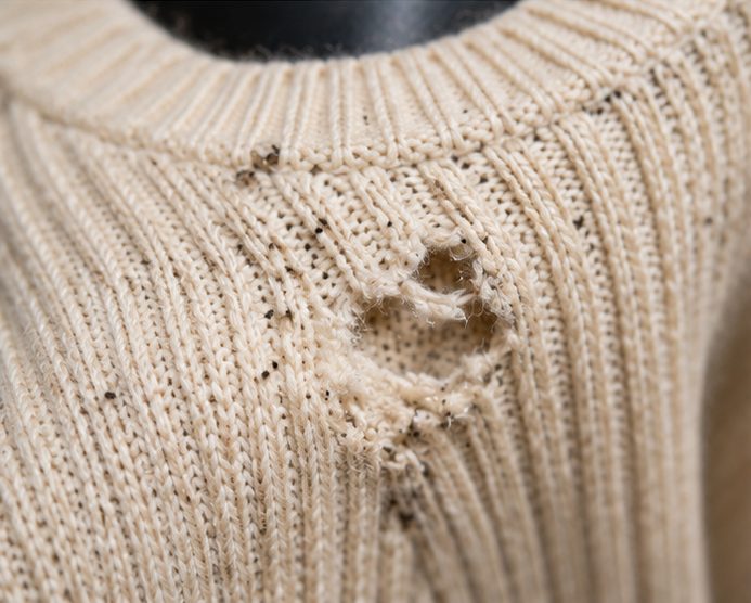Carpet moth damage along the edge of a wool carpet